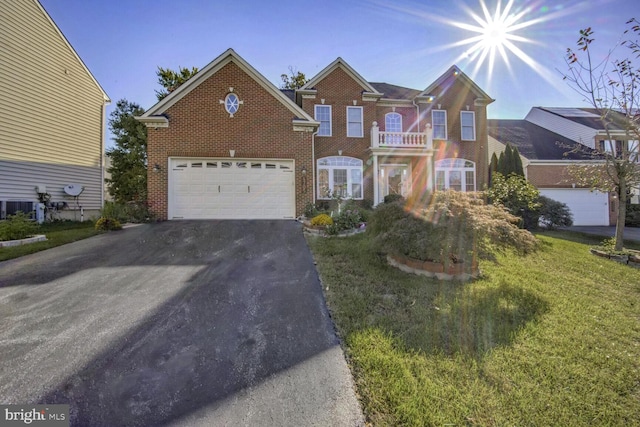 view of front of home featuring a front yard and a garage