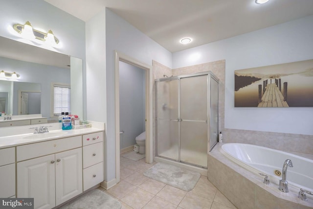 full bathroom with toilet, vanity, tile patterned floors, and independent shower and bath