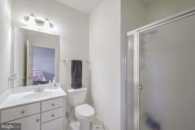 bathroom with vanity, toilet, and an enclosed shower