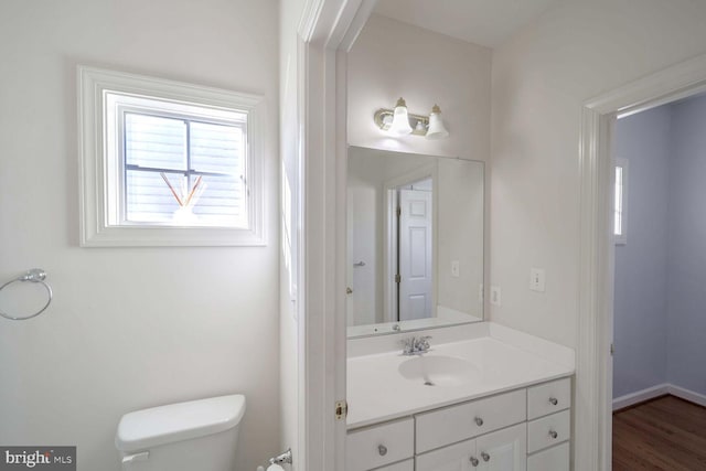 bathroom featuring hardwood / wood-style floors, vanity, and toilet