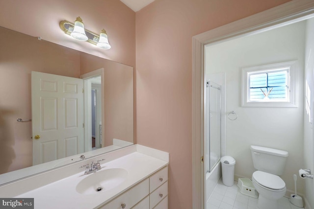 bathroom with tile patterned floors, toilet, vanity, and walk in shower