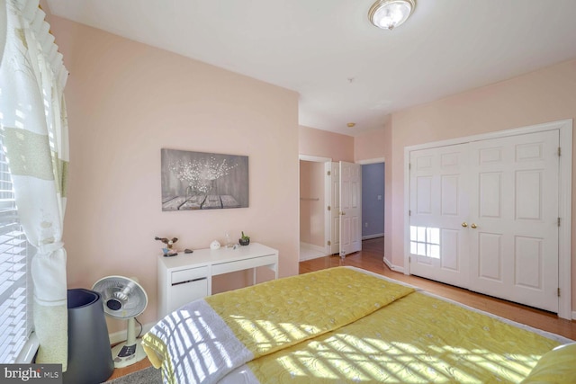 unfurnished bedroom with wood-type flooring and a closet