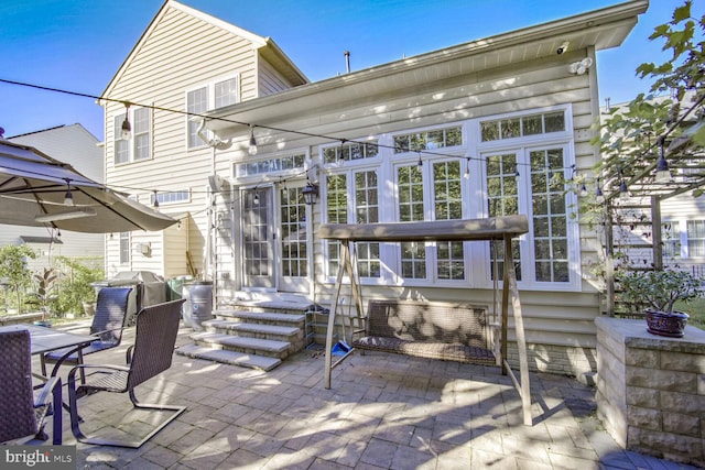 rear view of property featuring a patio area and french doors