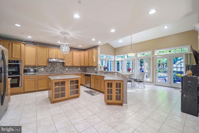 kitchen with pendant lighting, a center island, decorative backsplash, light tile patterned floors, and appliances with stainless steel finishes