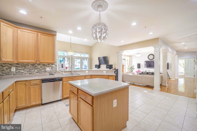 kitchen featuring dishwasher, a center island, sink, hanging light fixtures, and light tile patterned floors