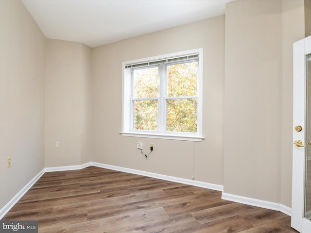 spare room with hardwood / wood-style floors