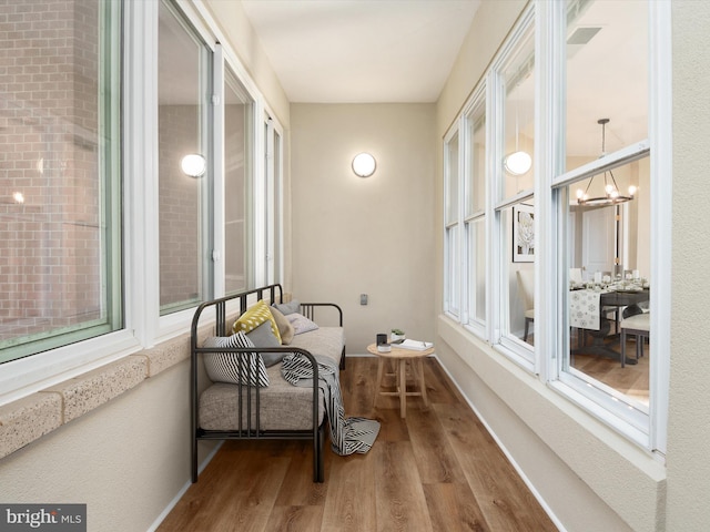 sunroom featuring a chandelier