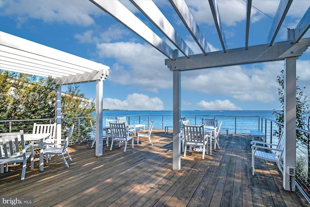 wooden deck featuring a water view and a pergola