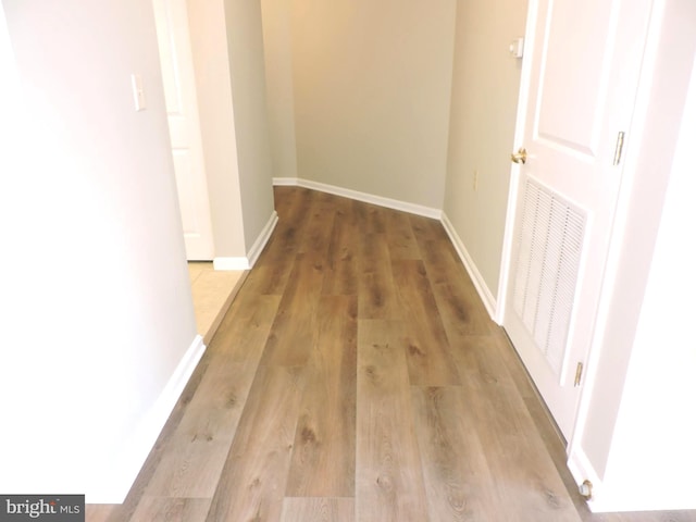 corridor with light wood-type flooring