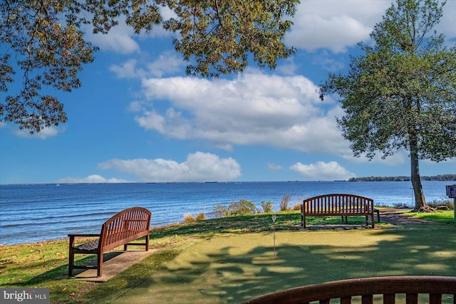 view of community with a lawn and a water view