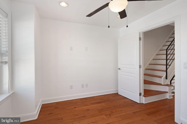 spare room with hardwood / wood-style flooring and ceiling fan