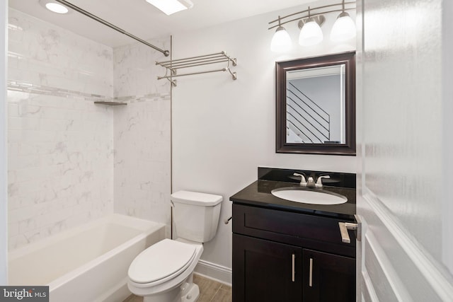 full bathroom featuring tiled shower / bath, hardwood / wood-style flooring, vanity, and toilet