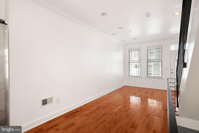 unfurnished room with crown molding and hardwood / wood-style floors