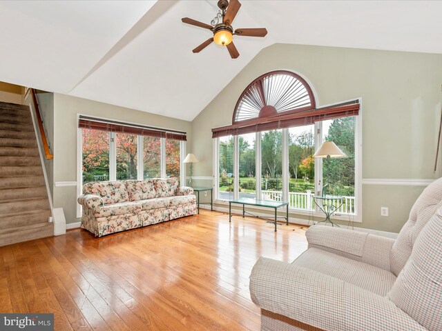 living room with light wood-type flooring, a healthy amount of sunlight, and ceiling fan