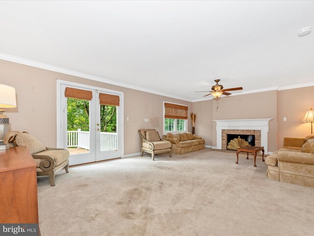 carpeted living room with crown molding and ceiling fan