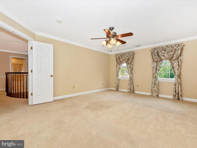 unfurnished room featuring crown molding, light colored carpet, and ceiling fan