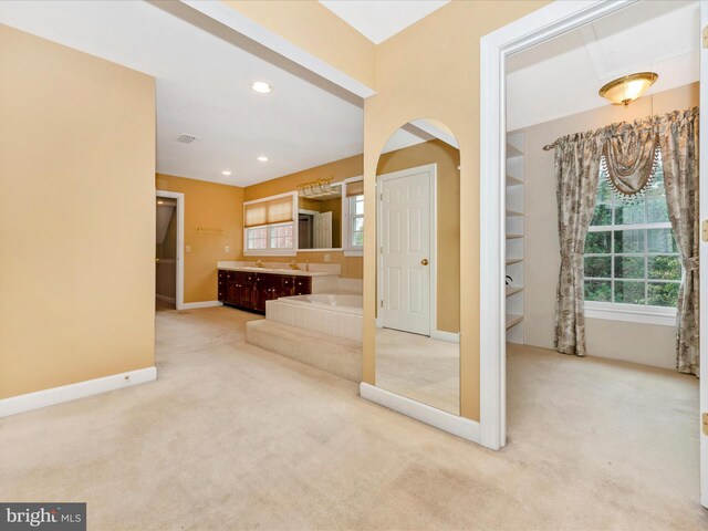 bathroom with vanity and a bath