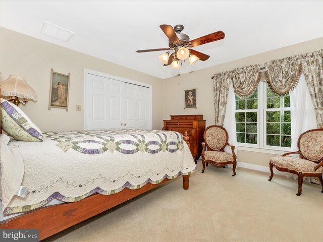 bedroom featuring ceiling fan, a closet, and carpet