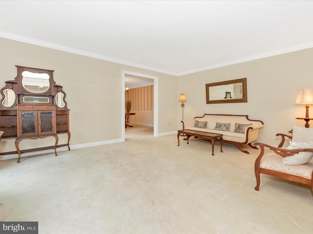 sitting room featuring ornamental molding and carpet