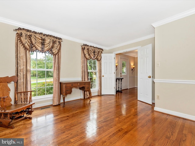 living area featuring ornamental molding and hardwood / wood-style flooring