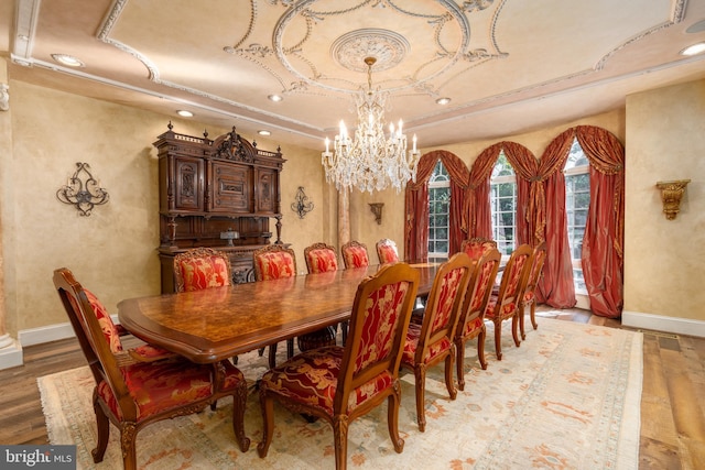 dining space with light hardwood / wood-style flooring and a chandelier