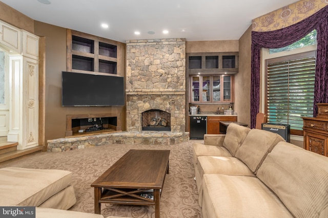 living room with indoor bar, plenty of natural light, and a stone fireplace