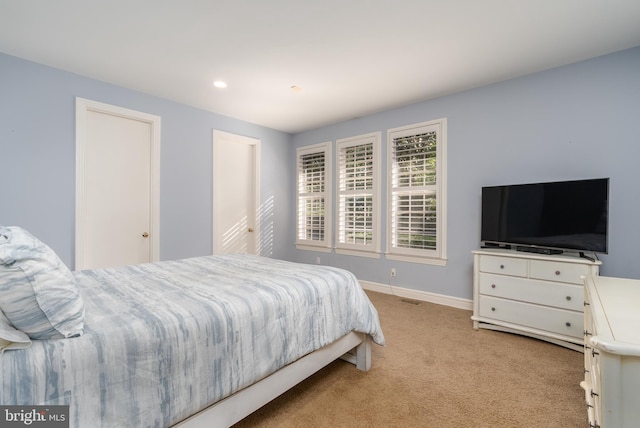 bedroom featuring light carpet