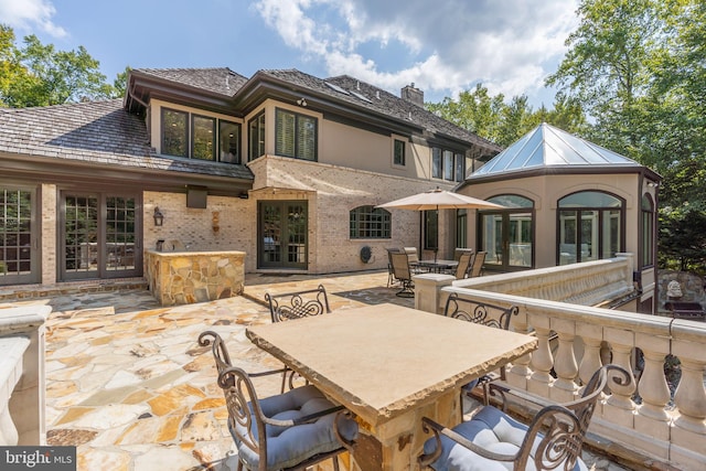 back of property with a patio and french doors