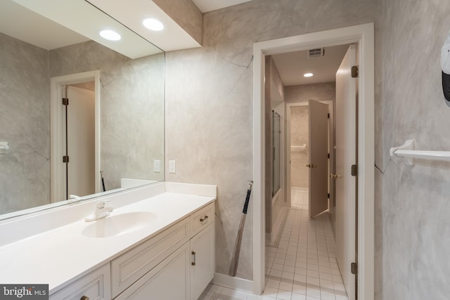 bathroom with tile patterned flooring and vanity