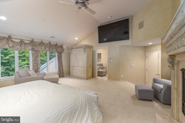 carpeted bedroom featuring a high end fireplace, high vaulted ceiling, and ceiling fan