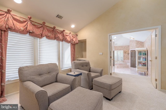 sitting room with light colored carpet and vaulted ceiling