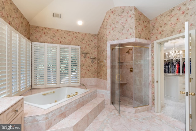 bathroom featuring a wealth of natural light, separate shower and tub, an inviting chandelier, and vanity