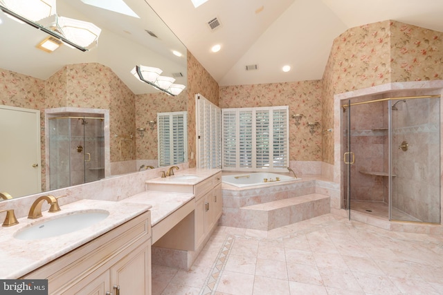 bathroom with tile patterned floors, lofted ceiling with skylight, vanity, and independent shower and bath