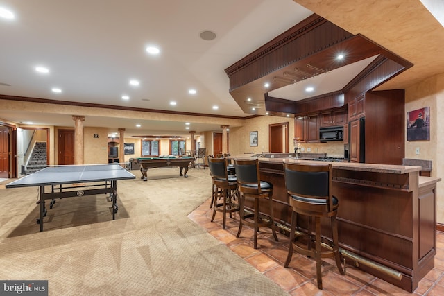 bar with ornamental molding, light carpet, paneled built in refrigerator, and billiards