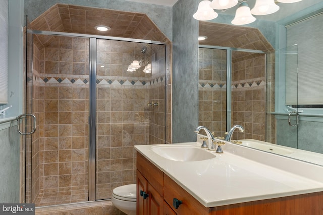 bathroom with vanity, toilet, and an enclosed shower