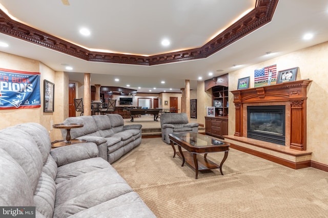 carpeted living room with crown molding and a tray ceiling