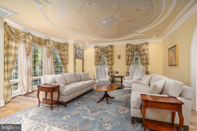 interior space with crown molding, a tray ceiling, and light hardwood / wood-style flooring