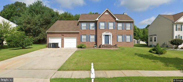 view of front of property featuring a garage and a front lawn