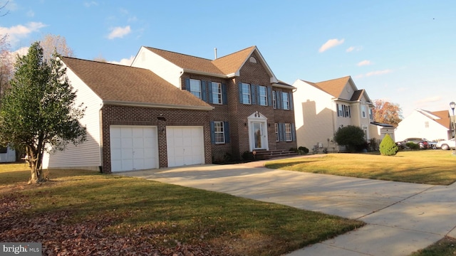 colonial home with a front lawn and a garage