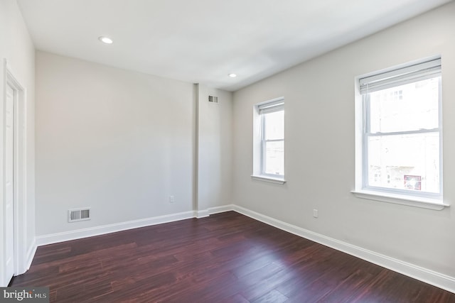 unfurnished room with dark hardwood / wood-style flooring