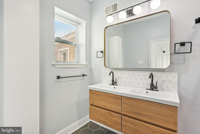 bathroom featuring vanity and tasteful backsplash