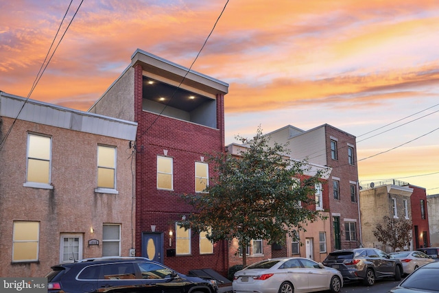 view of outdoor building at dusk