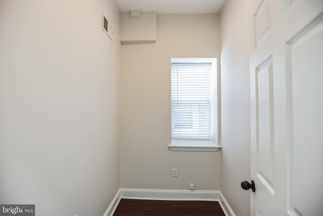 laundry area with wood-type flooring