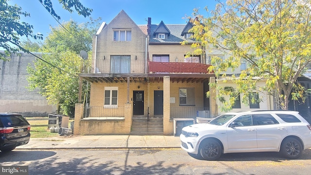 view of front of property with a balcony and covered porch