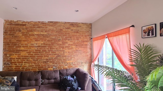 living room featuring brick wall