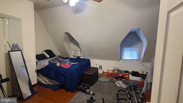 bedroom featuring ceiling fan, hardwood / wood-style floors, and lofted ceiling