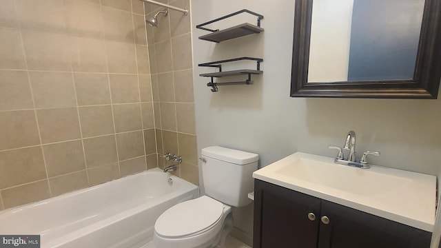 full bathroom featuring vanity, toilet, and tiled shower / bath combo