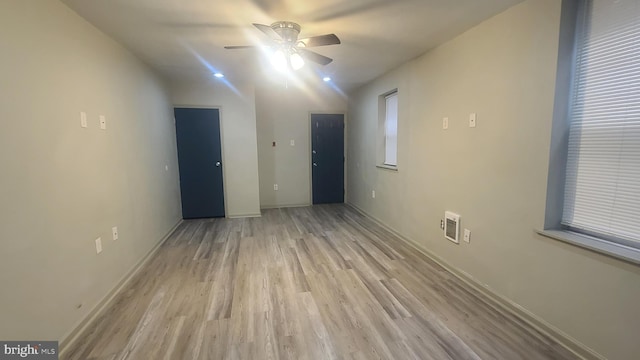 spare room featuring ceiling fan and light hardwood / wood-style flooring