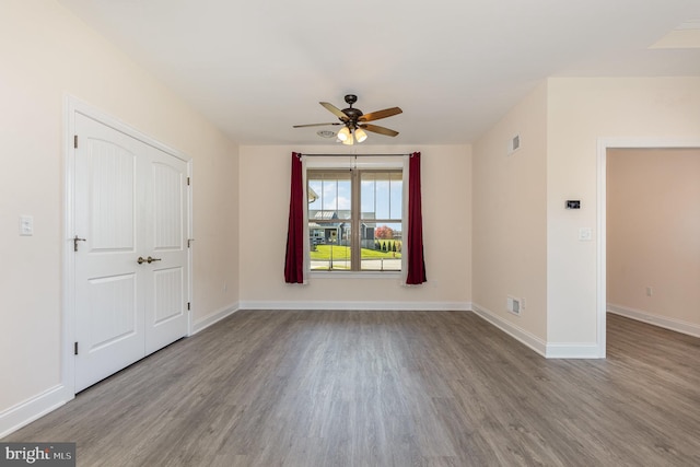 empty room with ceiling fan and light hardwood / wood-style flooring