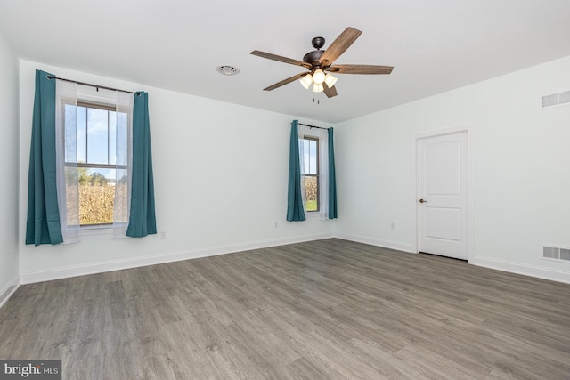 empty room with ceiling fan and hardwood / wood-style floors